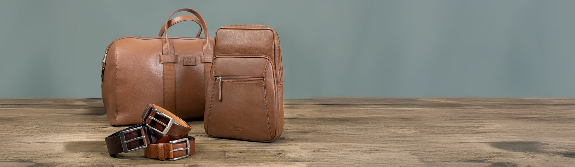 Two men's brown leather bags and three men's brown leather belts. 